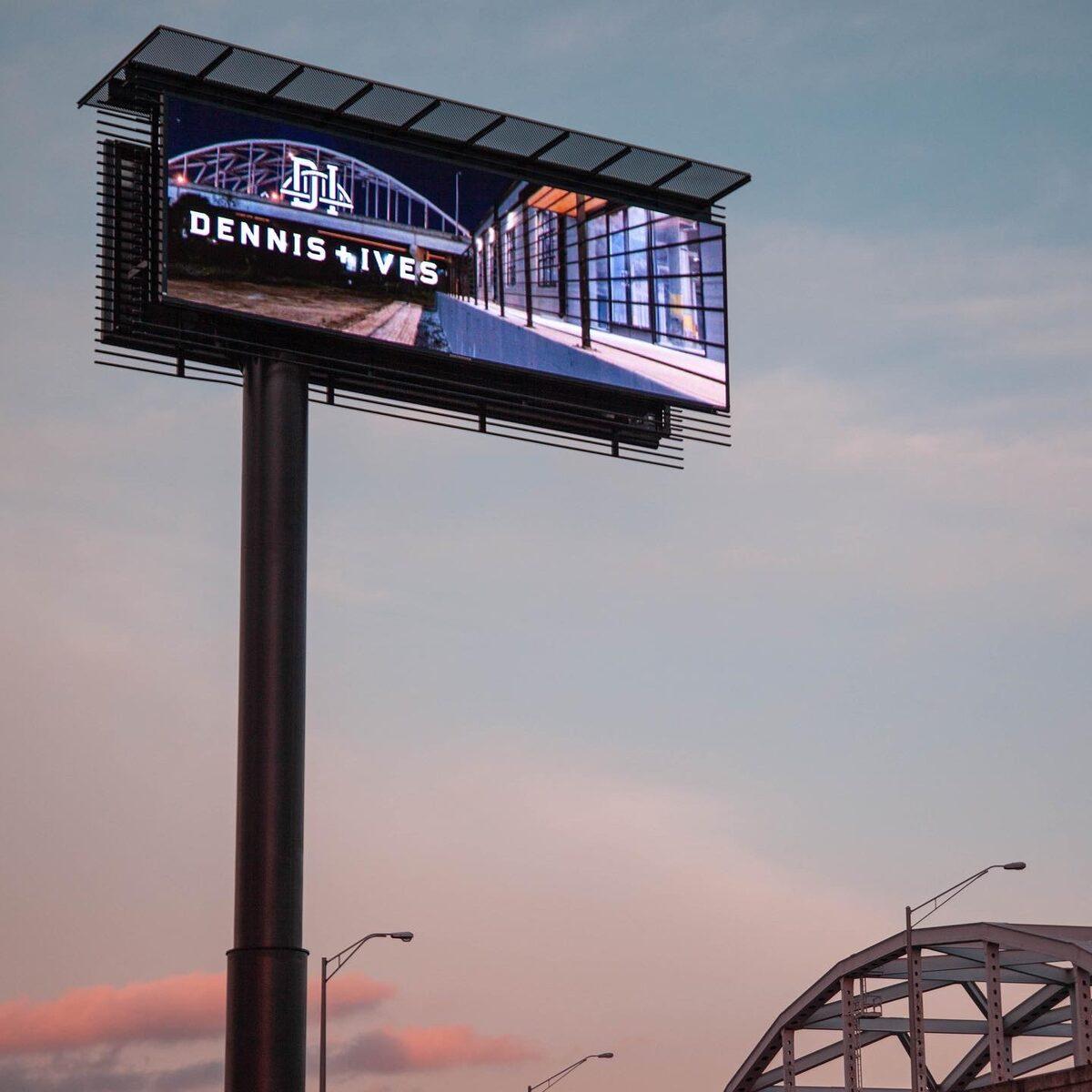 Dennis+Ives Daktronics LED billboard at sunset — installed by CG Signs, Jacksonville FL