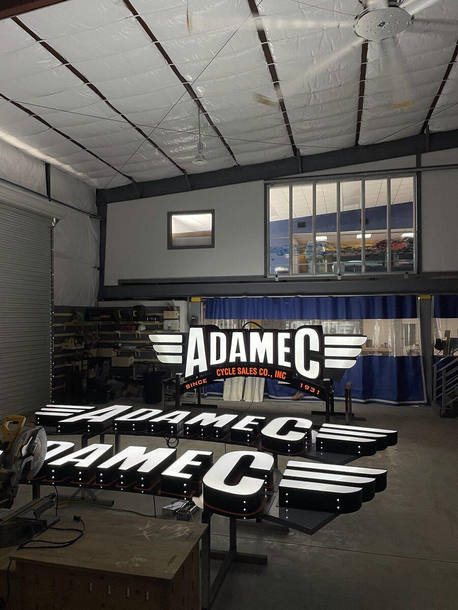 Custom-fabricated pylon sign cabinet and wall signs with channel letters for Adamec on Atlantic Boulevard, Jacksonville FL — by CG Signs