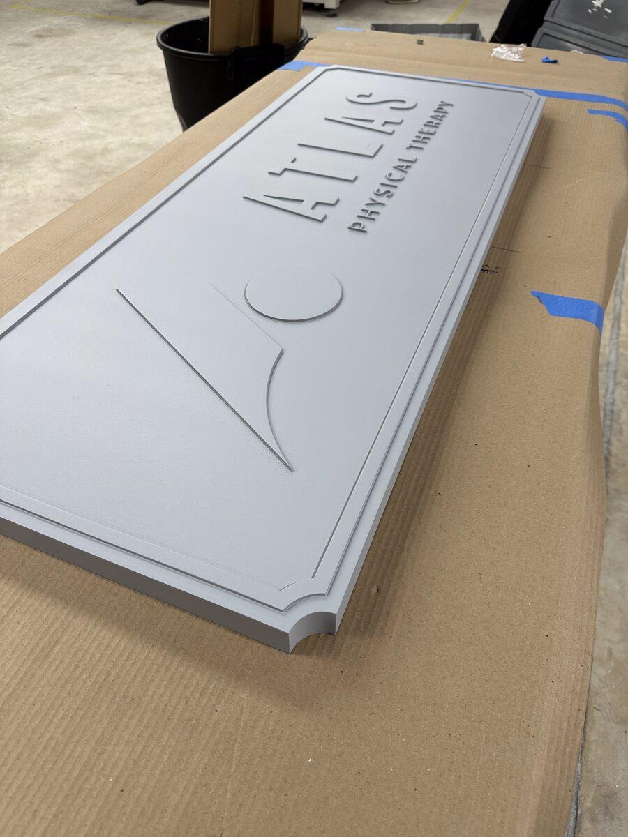 Carved HDU sign panel primed and ready for paint — CG Signs