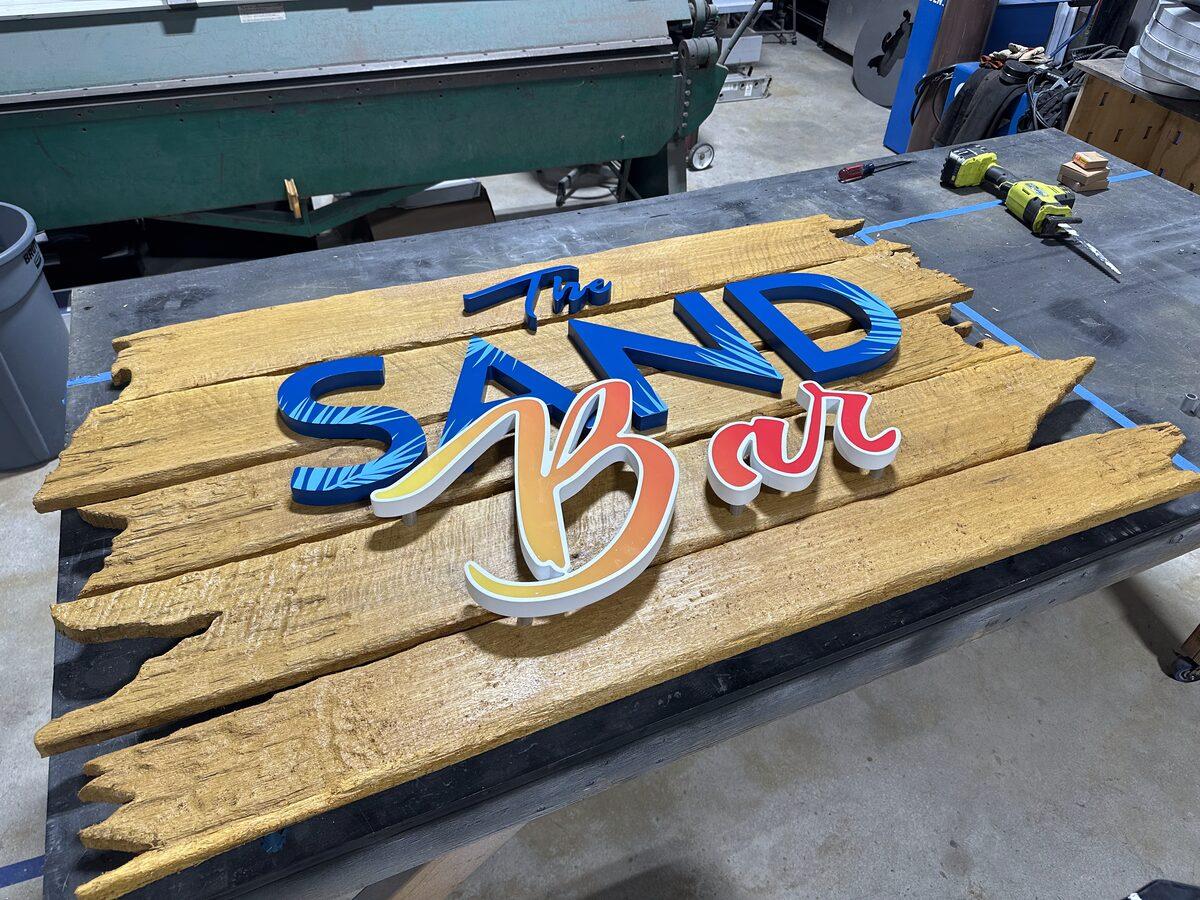 White oak sign panel with distressed finish and HDU dimensional letters — CG Signs Jacksonville FL