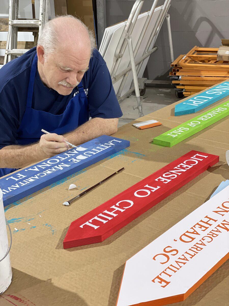 Handpainted details on wooden signs — CG Signs craftsmanship