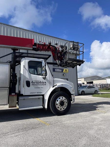 Our Service/Installation boom truck parked in front of our office — Custom Graphics & Sign Designs, Northeast Florida