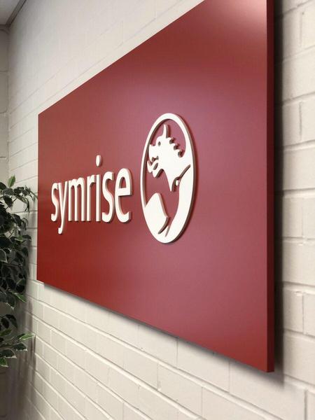 Fabricated aluminum panel sign with dimensional acrylic letters for Symrise — Custom Graphics & Sign Designs, Orange Park FL