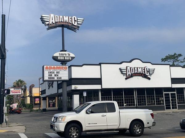 Installed view of the custom fabricated pylon sign cabinet and wall signs with Channel Letters for Adamec on Atlantic Blvd in Jacksonville, FL — Custom Graphics & Sign Designs