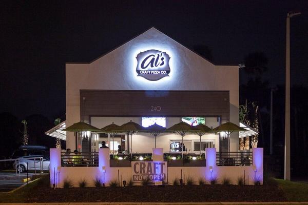Installed view of the custom Al's wall sign showing the various types of illumination — Custom Graphics & Sign Designs, Orange Park FL