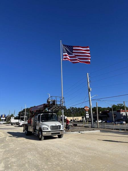 Installation of Flag Pole — Custom Graphics & Sign Designs