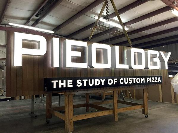 Fabricated wall sign with Ipe Wood background and Front/Back Lit Channel Letters — Custom Graphics & Sign Designs, Jacksonville FL