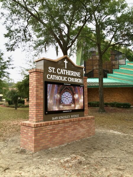 Custom monument sign with brick masonry and Daktronics LED display for St. Catherine Catholic Church Orange Park FL — designed and fabricated by Custom Graphics & Sign Designs